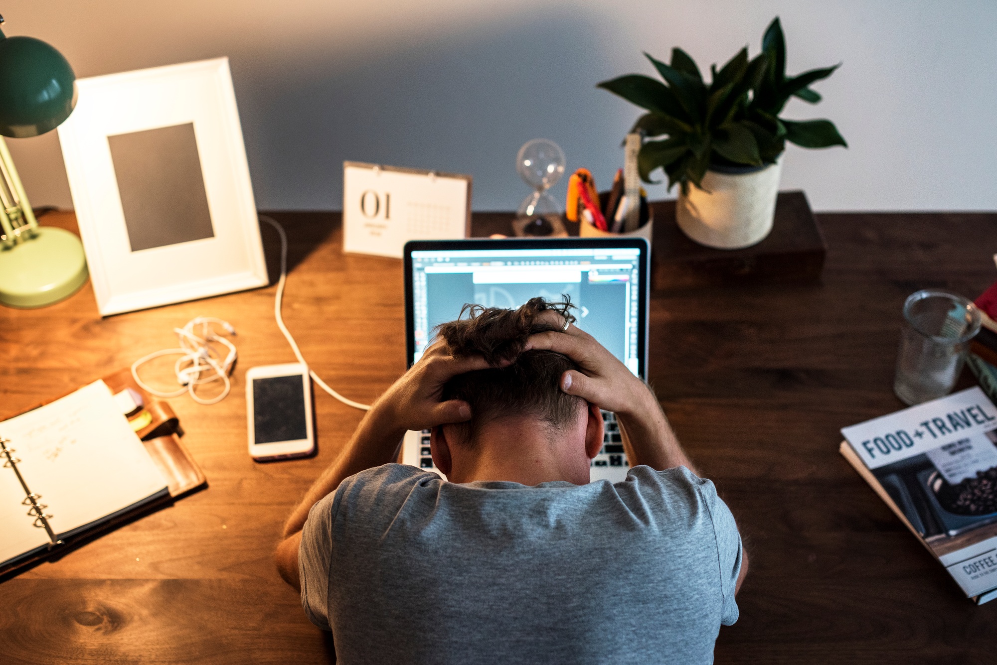 Man stressed while working on laptop