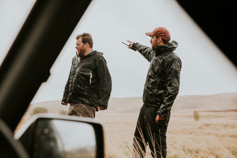 Men holding a walkie talkie outdoors
