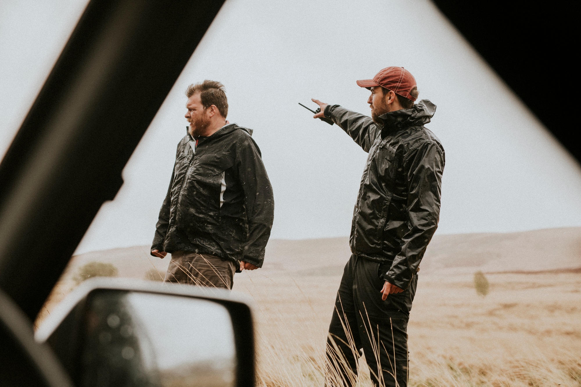 Men holding a walkie talkie outdoors